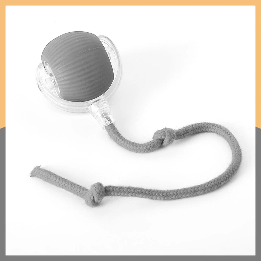 A grey ribbed spherical object attached to a clear plastic casing with a braided grey cord.
