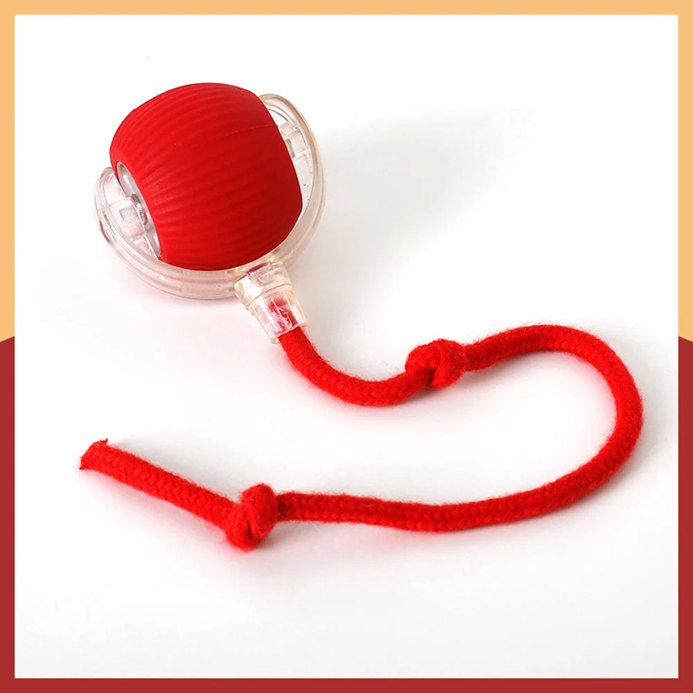 A red ribbed plastic ball inside a clear casing with a red string attached.