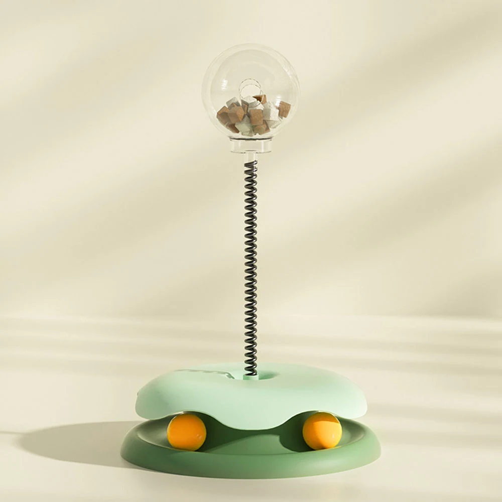 Green and mint interactive cat toy with a treat dispenser and spring-mounted ball
