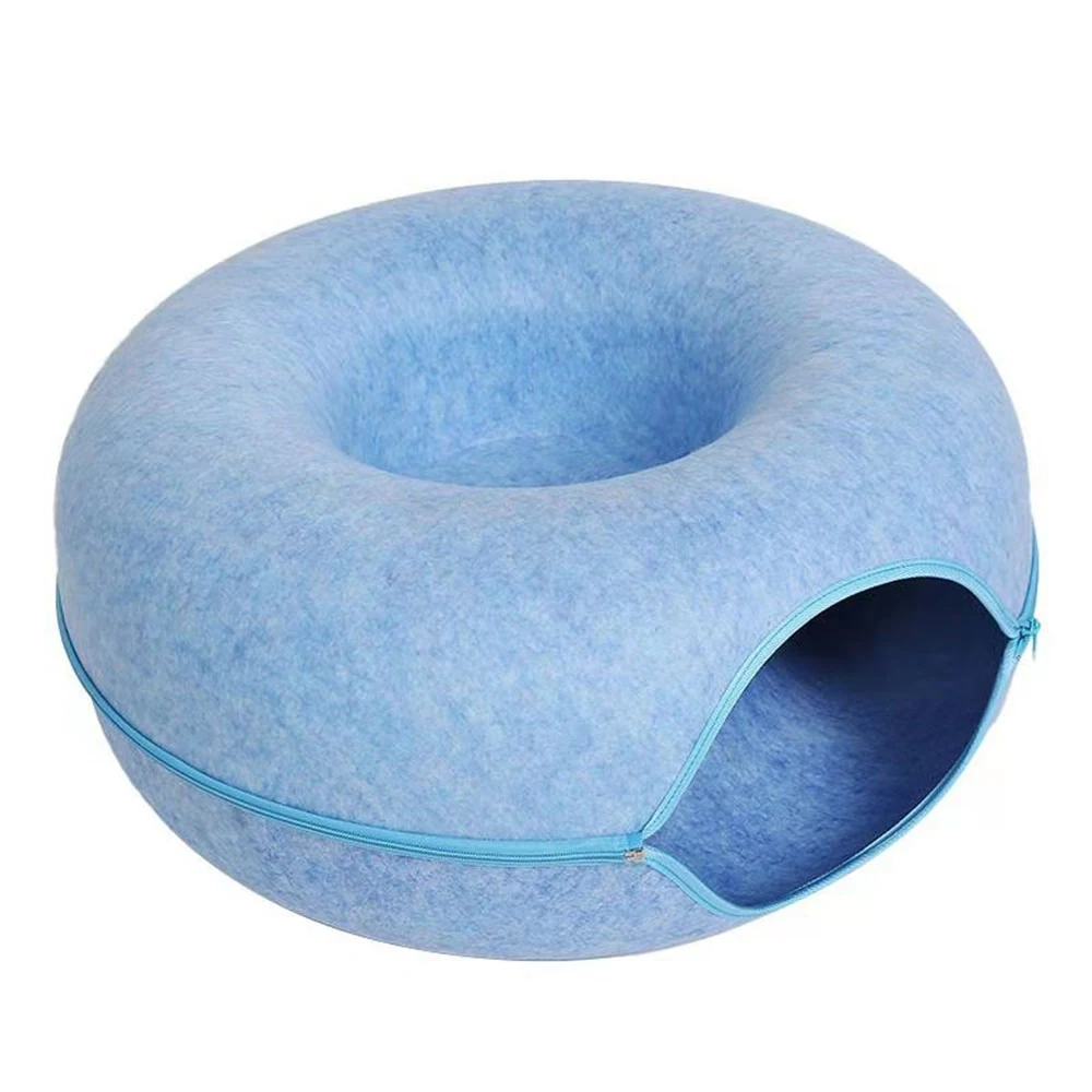 Blue felted donut-shaped pet bed with a circular entrance and zipper detail on a white background