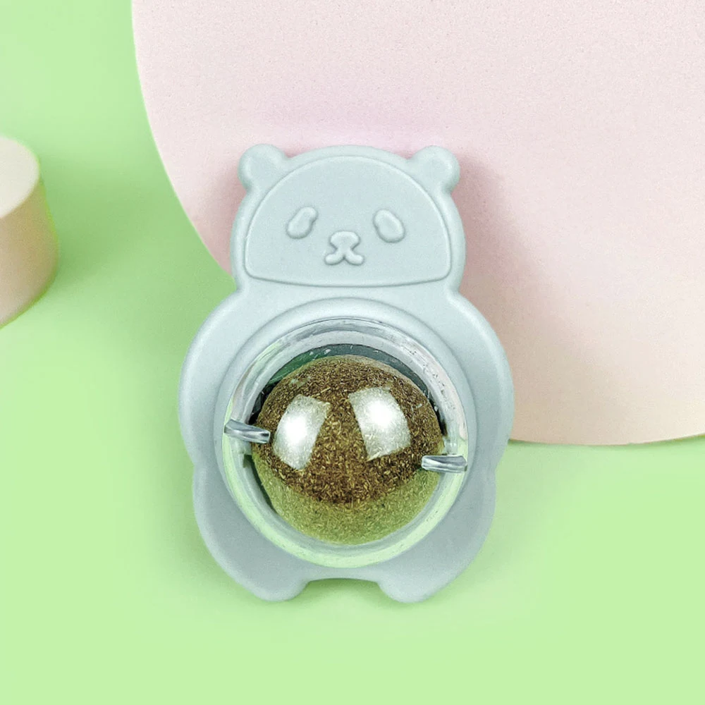 A grey cat-shaped toy featuring a clear dome containing a glittery golden ball.