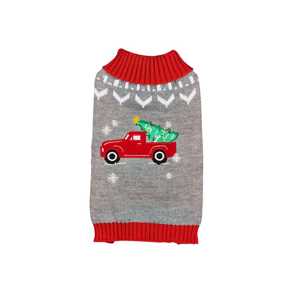 A grey knitted pet sweater with red cuffs and a festive design of a red truck carrying a Christmas tree.