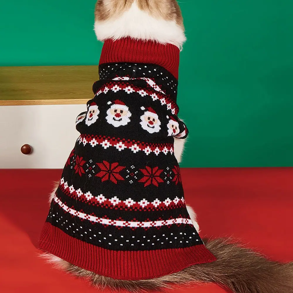 Back view of a dog wearing a black and red knitted Christmas sweater with a Santa face pattern.