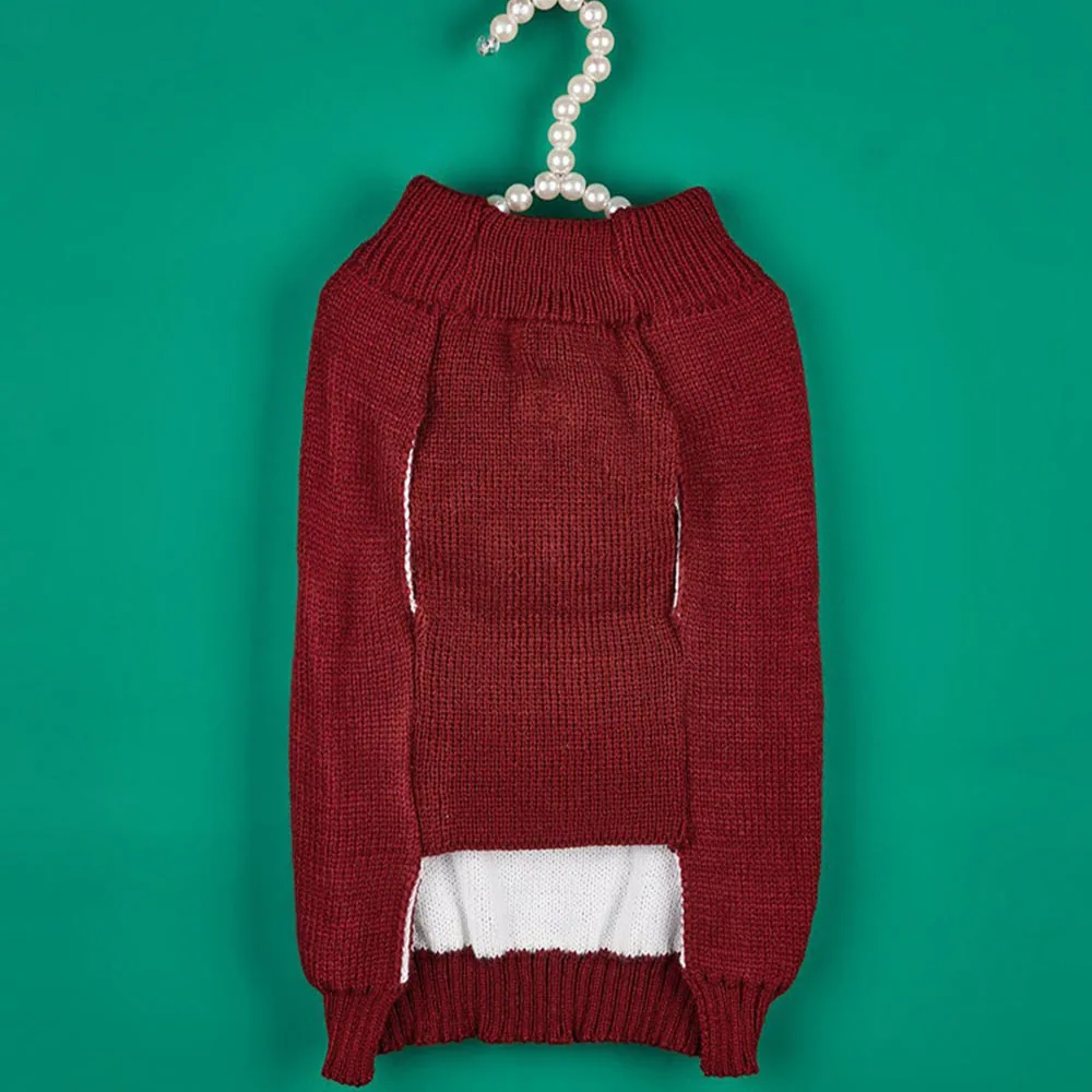 Back view of a maroon knit sweater with a white undershirt peeking out, hanging on a pearl-covered hanger against a teal background.