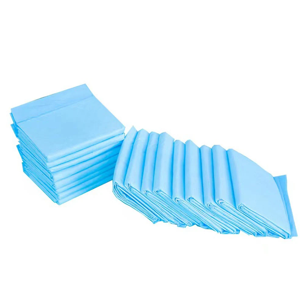Two stacks of folded light blue underpads or medical chux on a white background