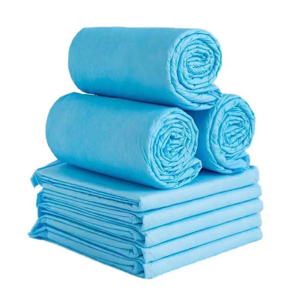 Stack of blue disposable underpads with three rolled pads on top of folded pads