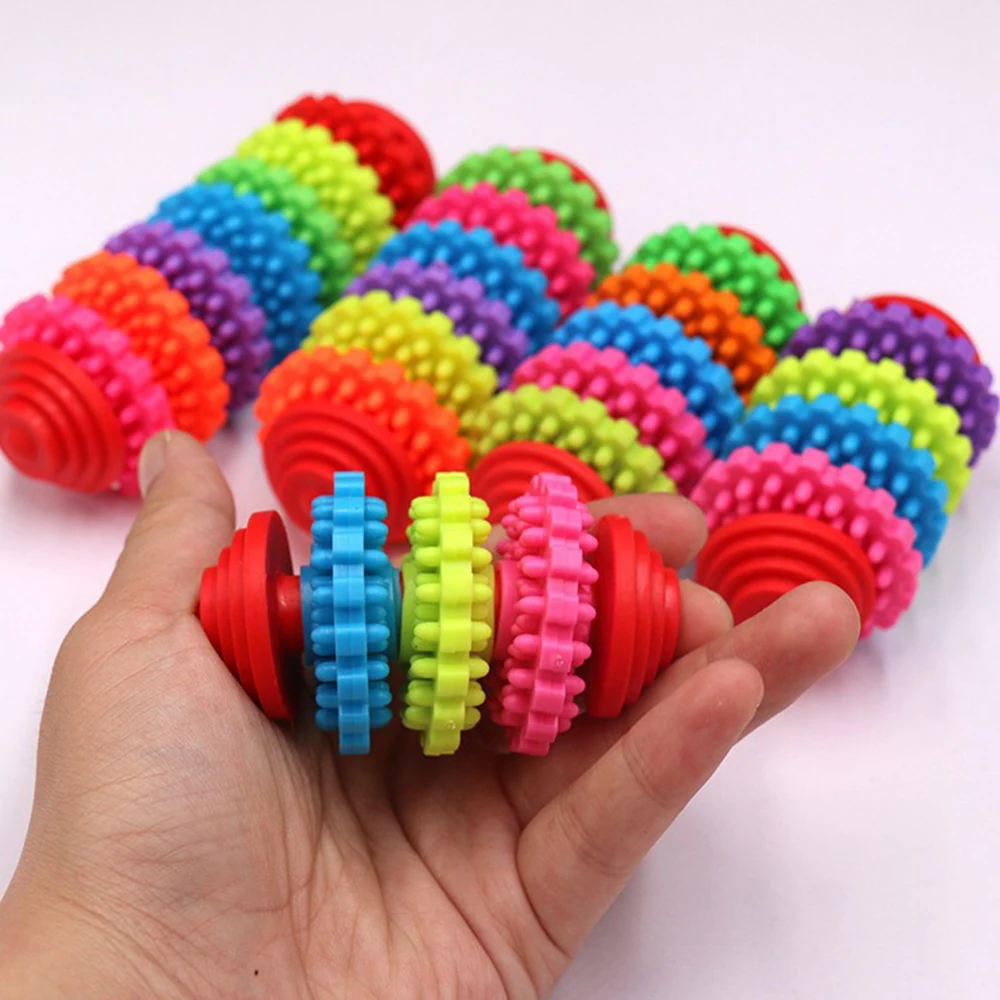 Hand holding colorful spiky massage ball with multiple others in background