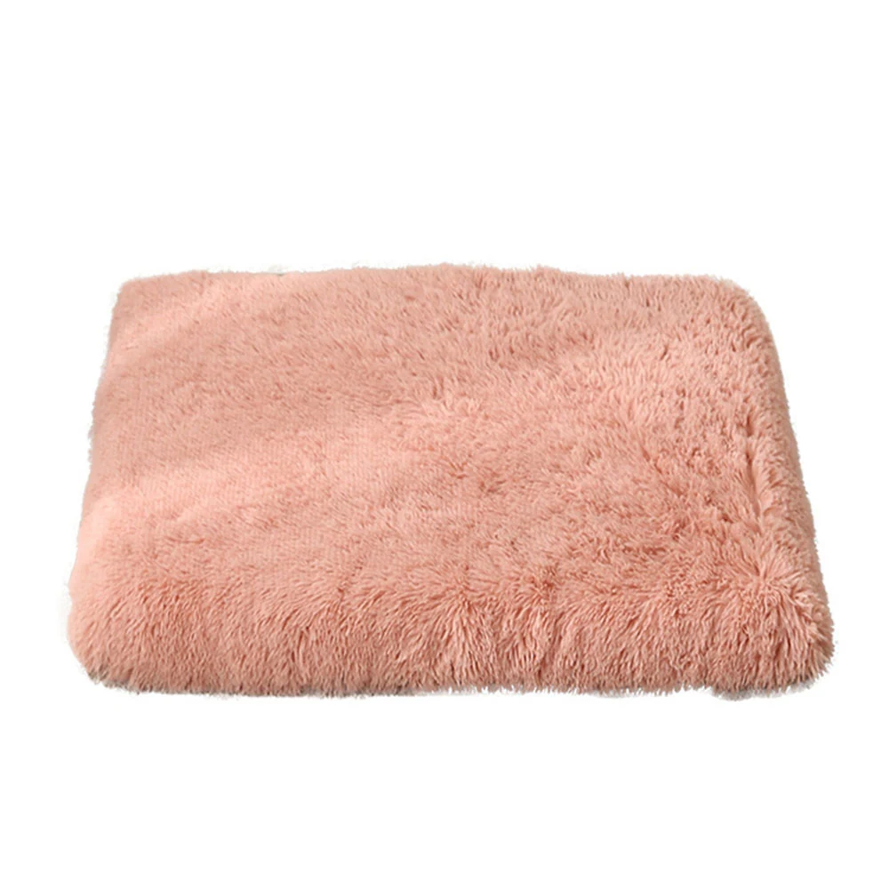 Folded pink faux fur blanket on a white background