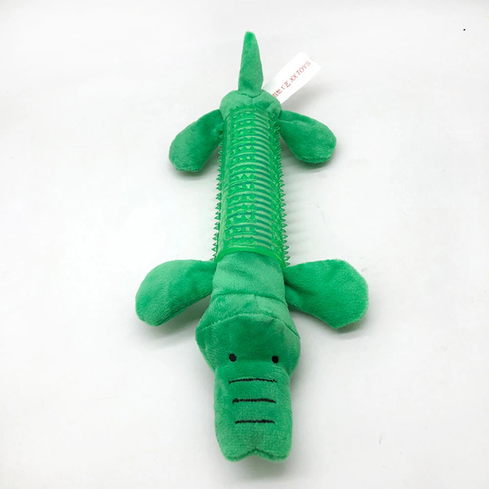 Green plush crocodile toy with a ribbed body and stitched face on a white background