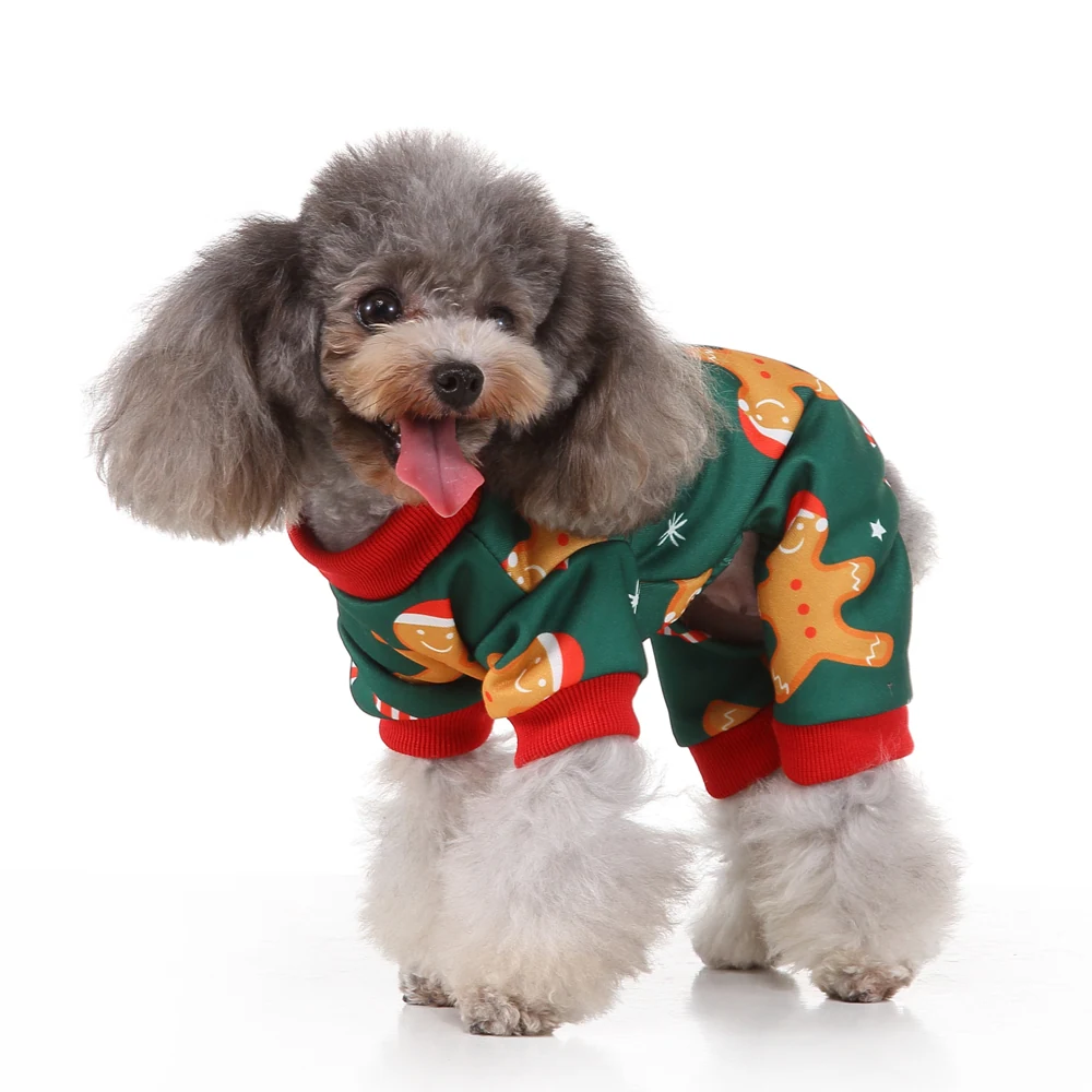 Gray poodle wearing green Christmas pajamas with gingerbread man pattern