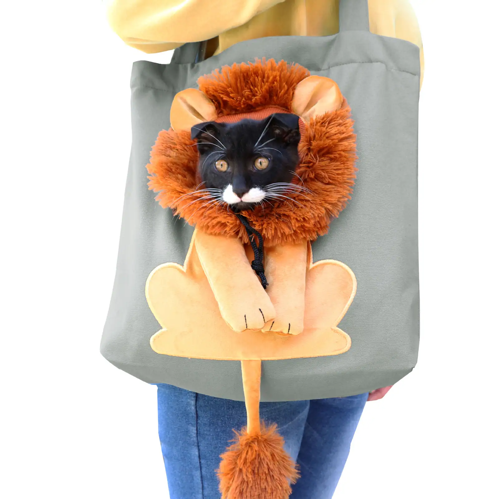 A person carrying a grey tote bag featuring a plush lion head and body design with a real cat's face peeking out from the center.