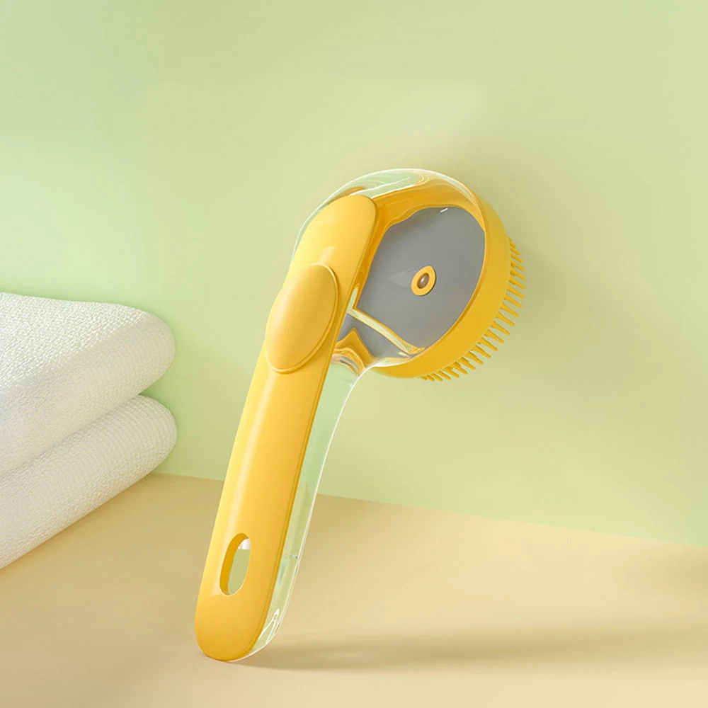 Yellow pet grooming brush with a clear protective cover and soft bristles.