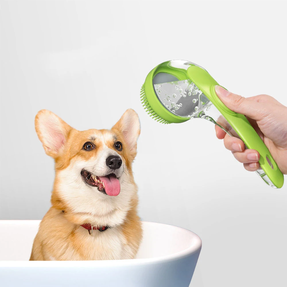 A hand holds a green pet shower sprayer brush over a corgi in a white bathtub.