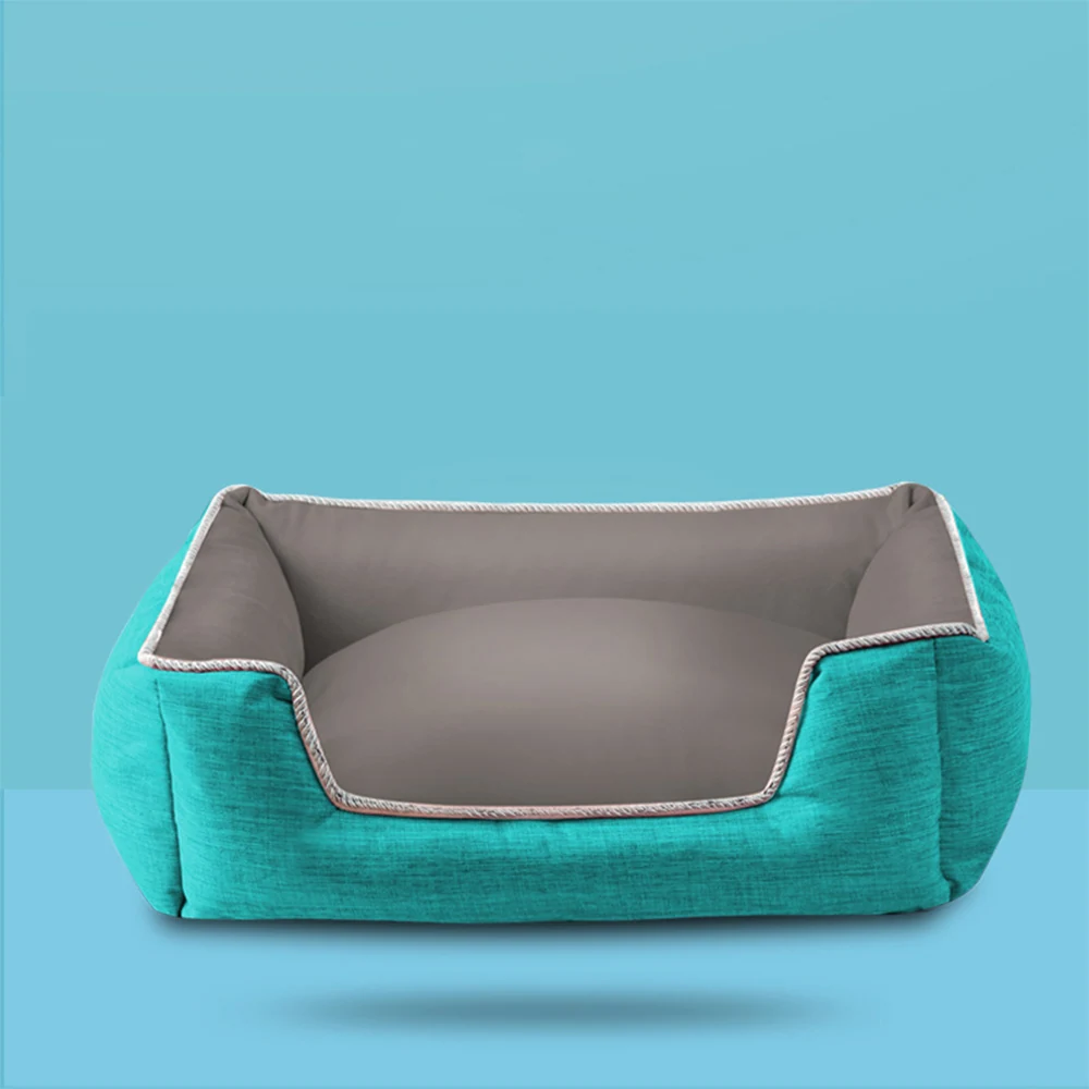 Teal rectangular pet bed with gray interior and piped trim on a blue background