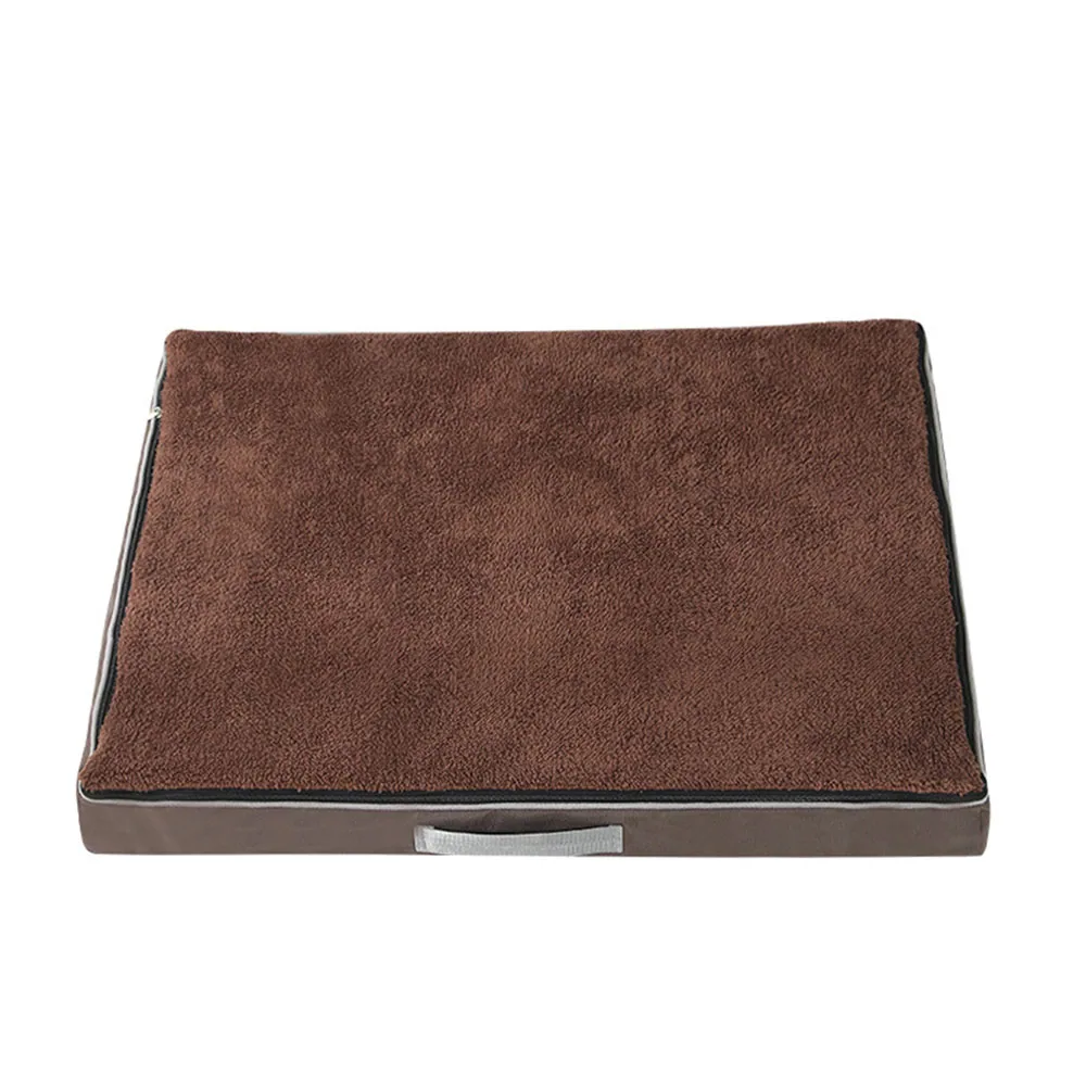 A rectangular brown cushioned mat with a textured surface and a carrying handle.