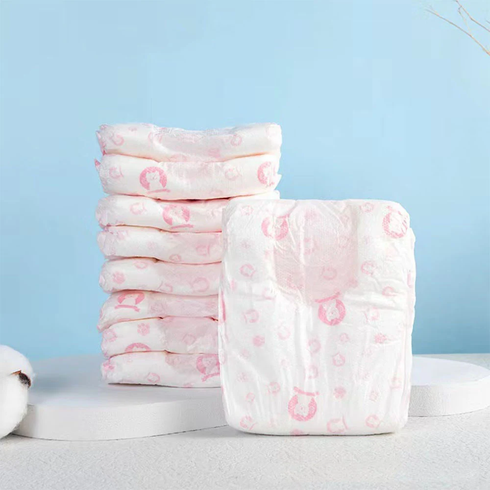 Stacked white baby diapers with pink patterns displayed on a white stand against a light blue background.
