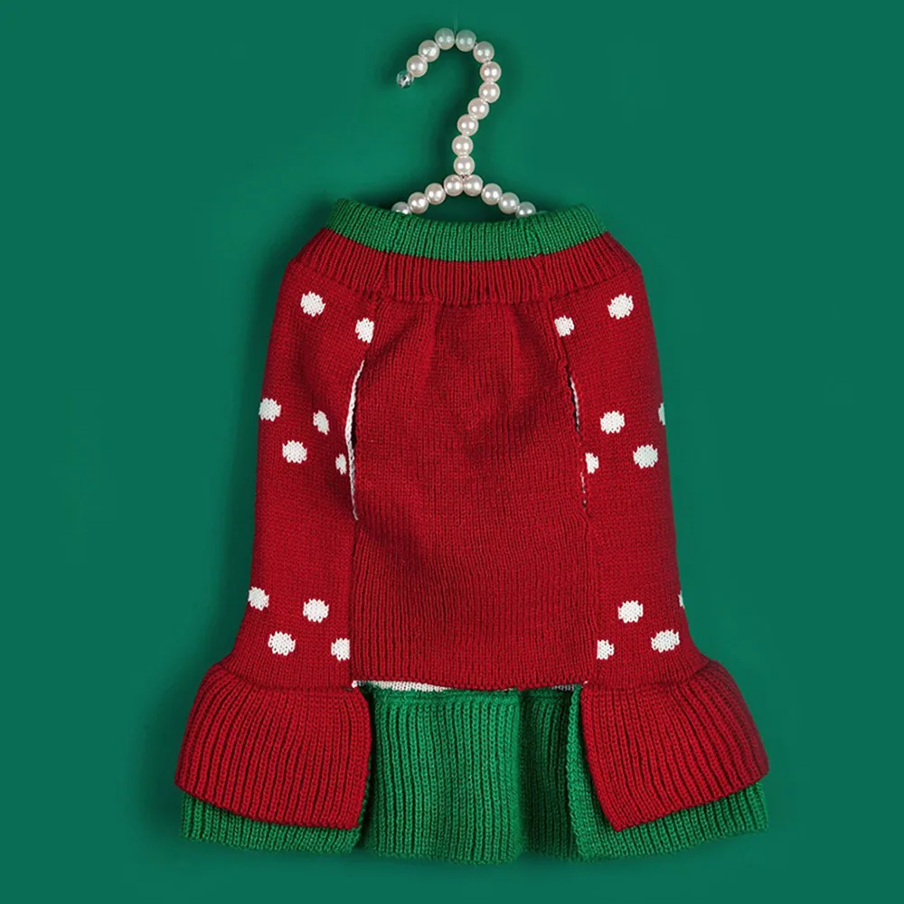 Red knitted sweater with white dots and green trim on a pearl hanger