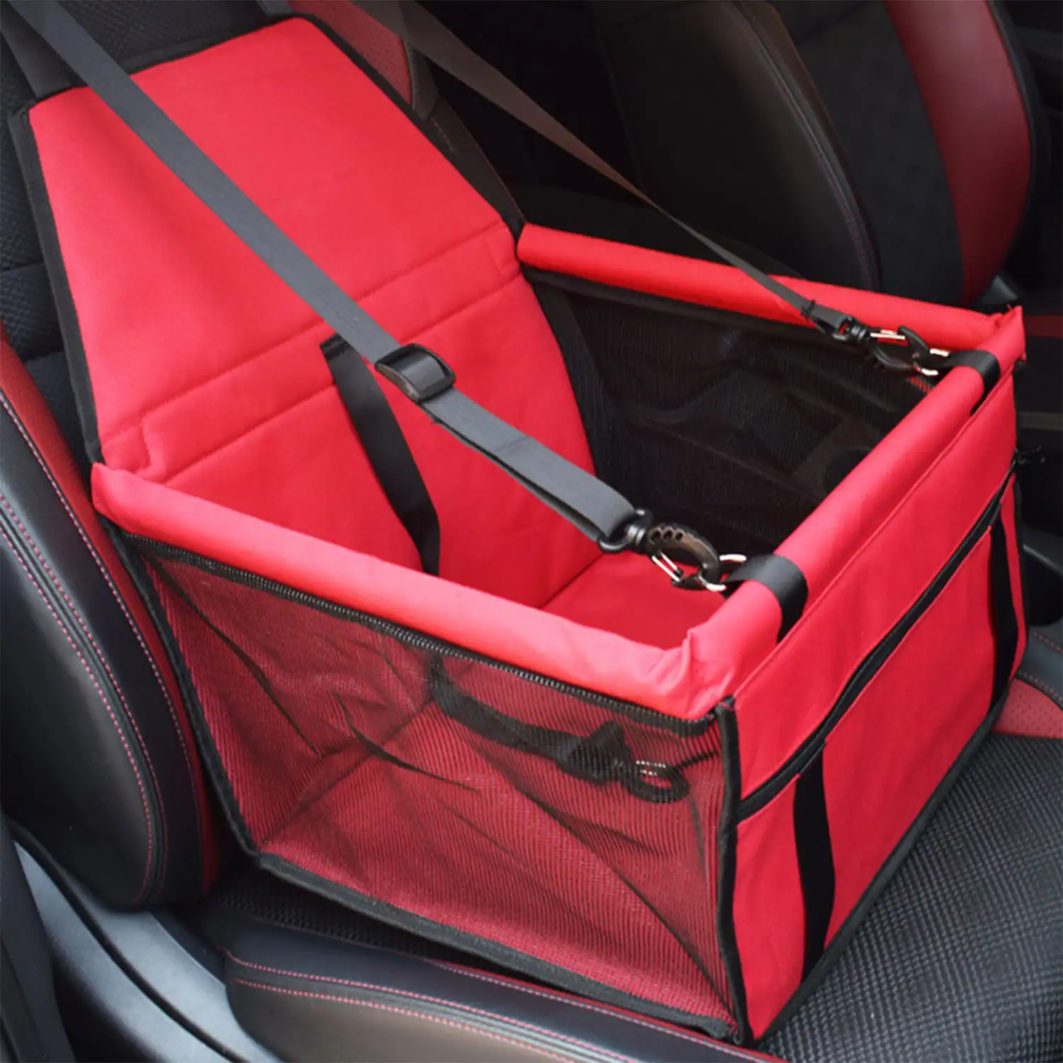 Red pet car seat cover with mesh sides and safety straps installed on a car seat