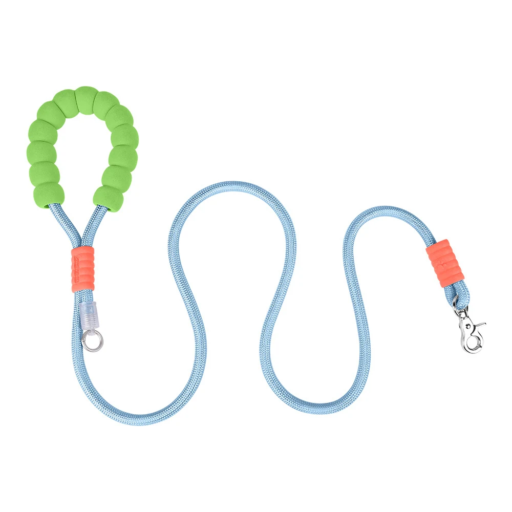 A light blue dog leash with a segmented bright green foam handle and orange accents, laid out in a serpentine shape.