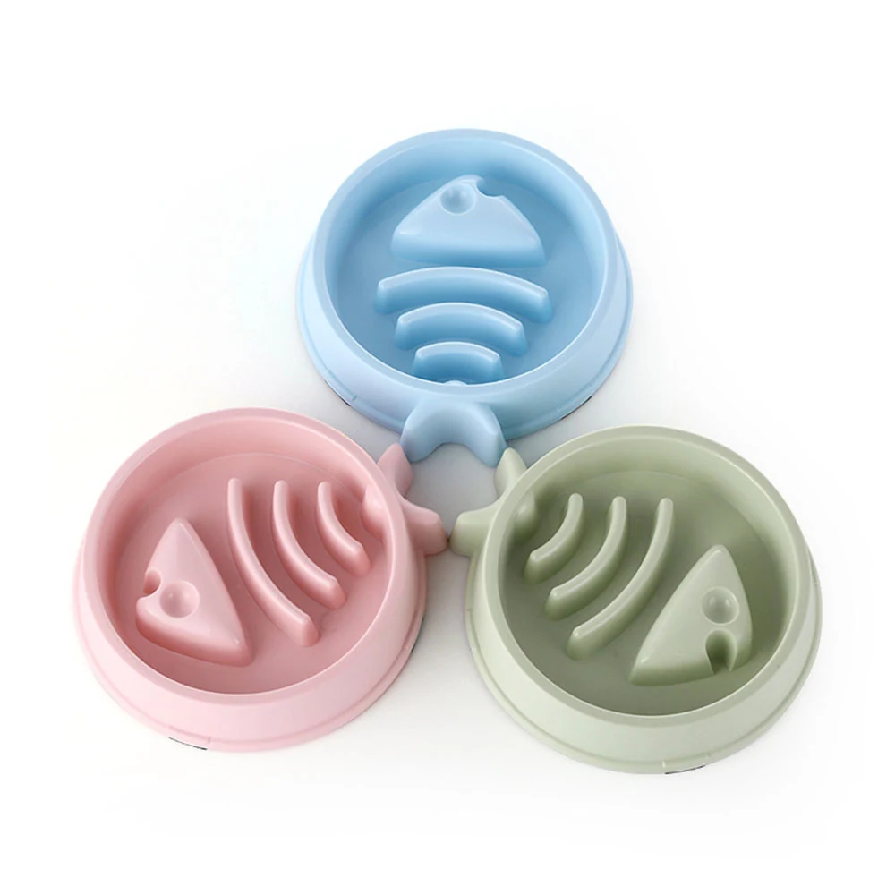 Three silicone molds in blue, pink, and green shaped like fish skeletons