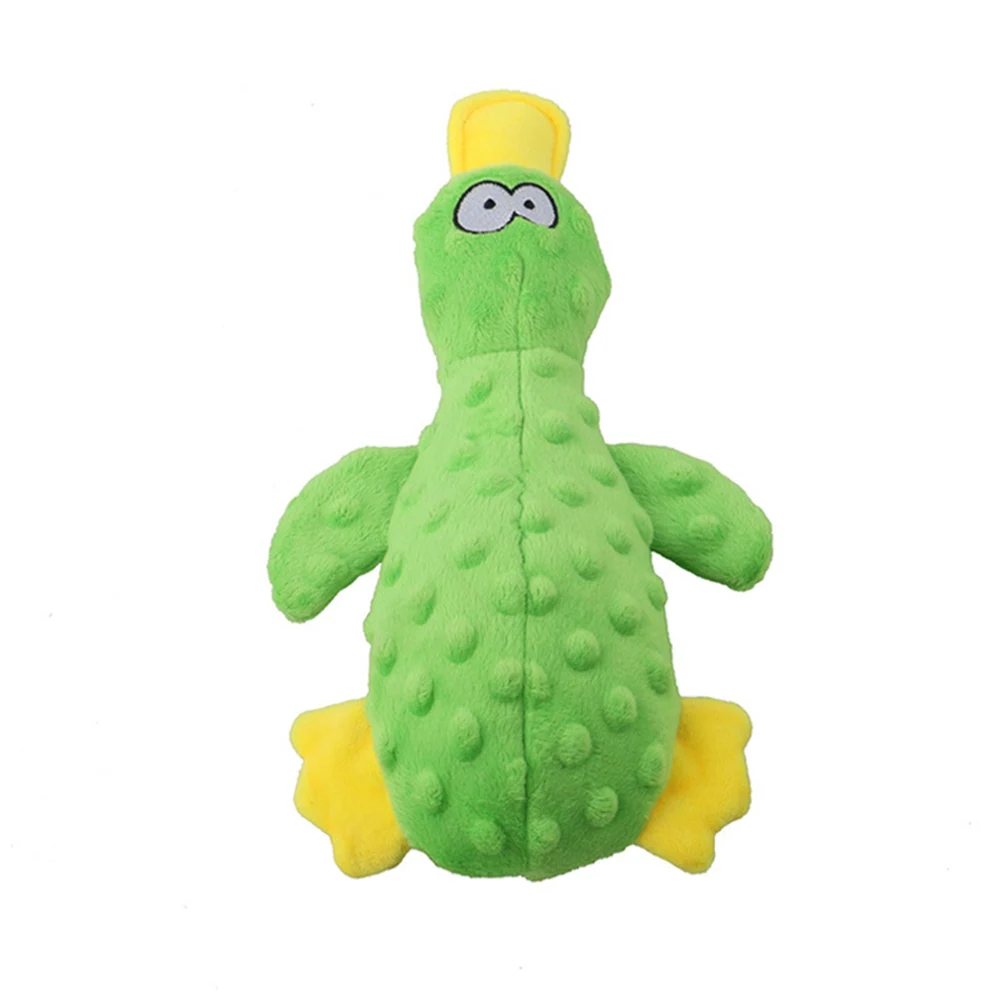 Green plush toy with bumpy texture, yellow feet and beak, and cartoon eyes on a white background