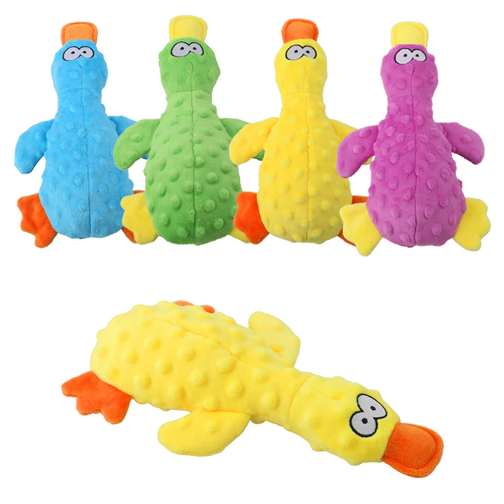 Four plush squeaky toy birds in blue, green, yellow, and purple, with a yellow one lying down.