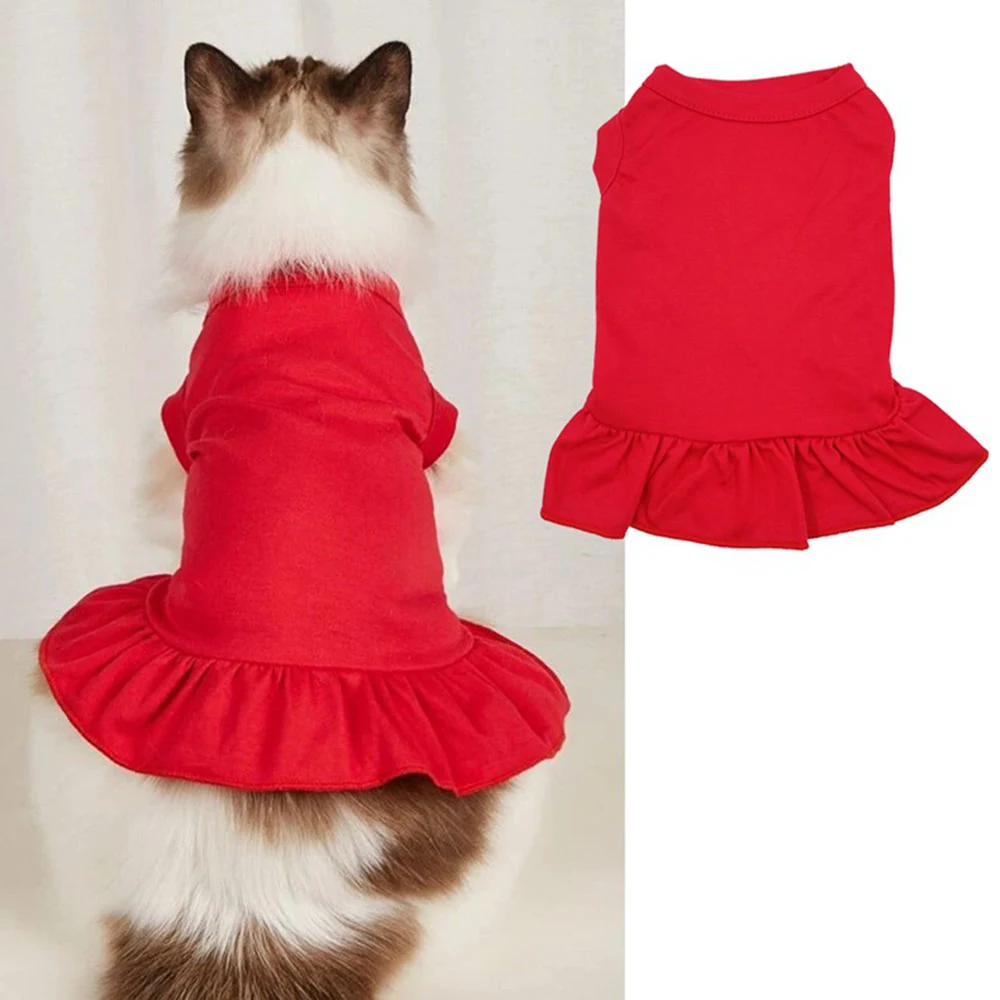 A red sleeveless pet dress with a ruffled hem, shown worn by a fluffy cat and as a standalone garment.
