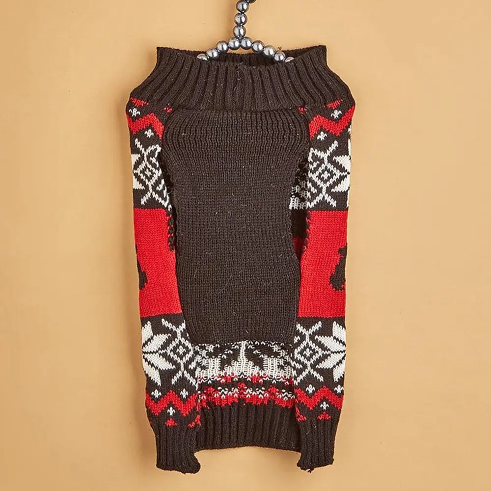 Knitted dog sweater with red, white, and black Nordic pattern hanging on a hook