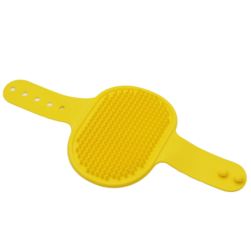 Yellow silicone scrubber with textured center and adjustable strap tabs.