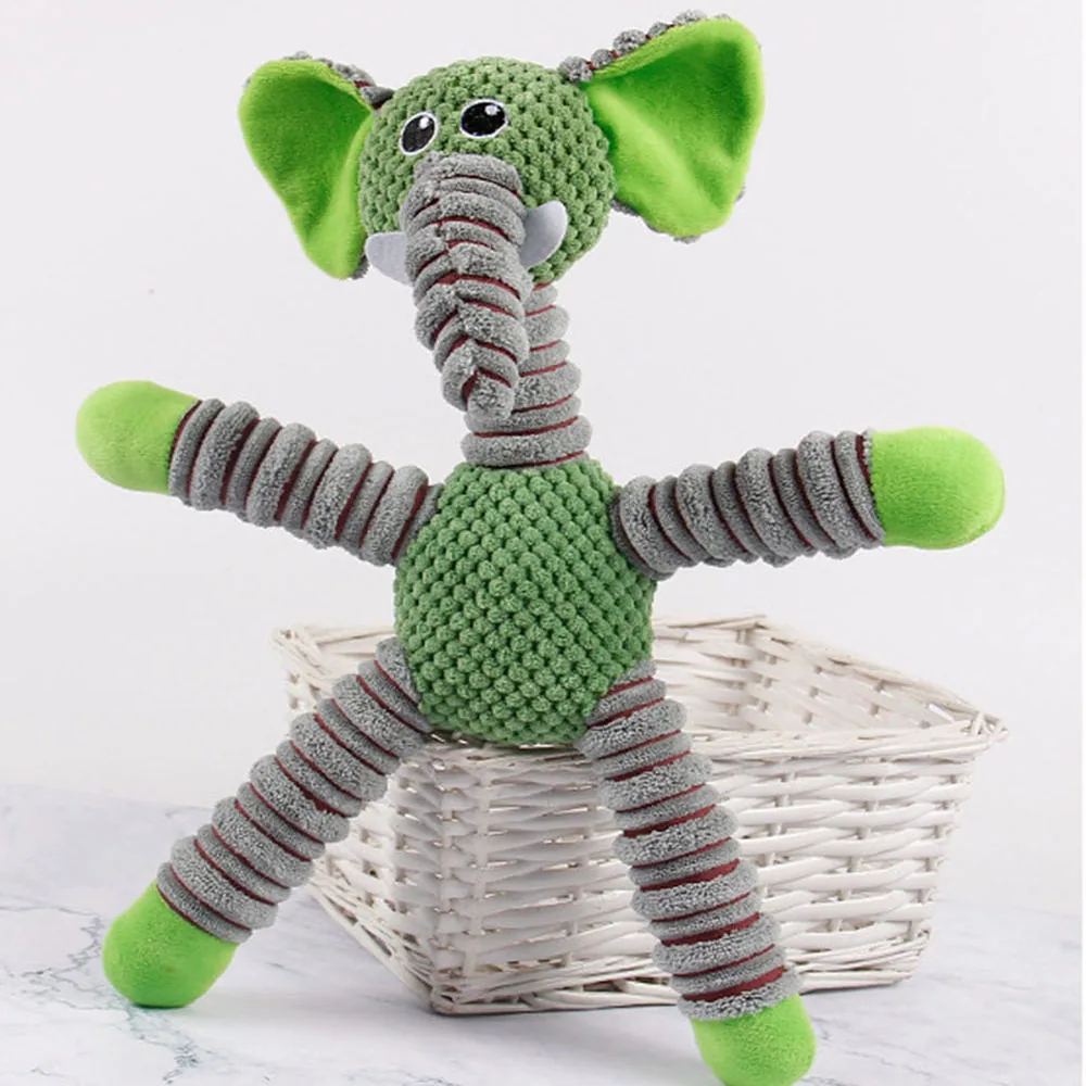 Green and grey crocheted elephant toy sitting in a white basket