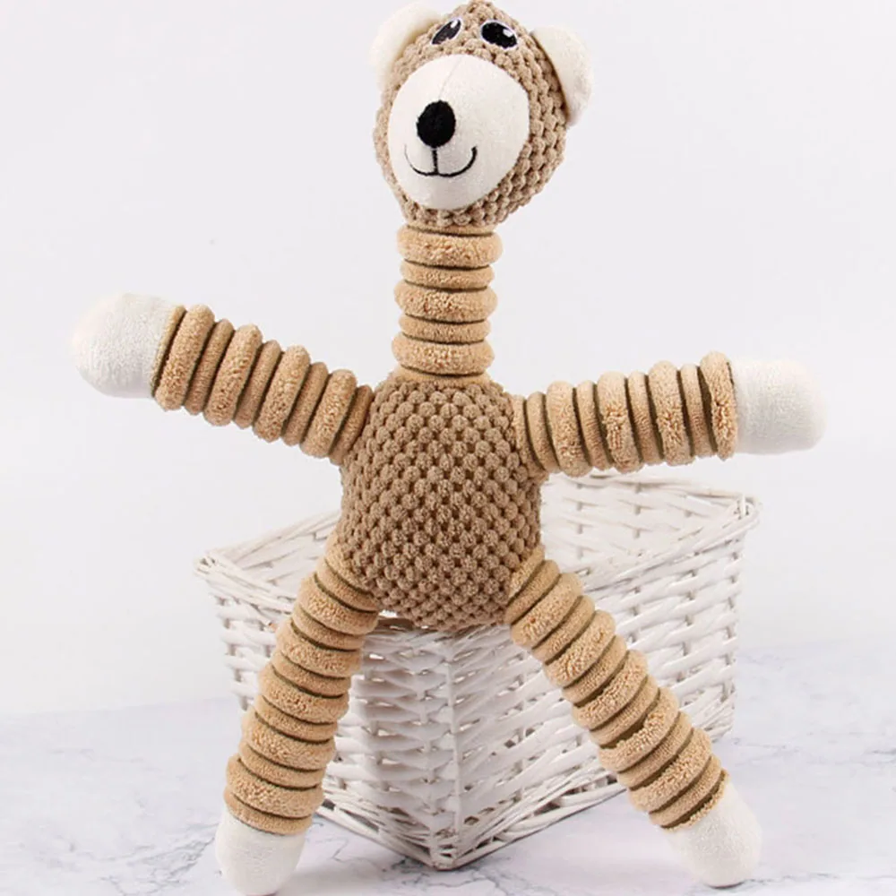Tan and white knitted plush monkey toy standing in front of a white basket