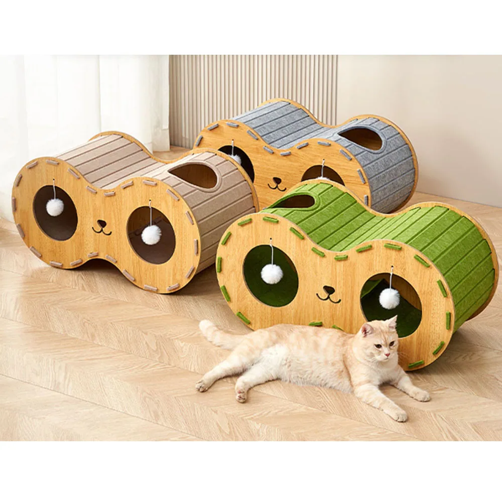 Three wooden cat scratchers in tan, gray, and green with pom-pom toys, accompanied by a resting cat.