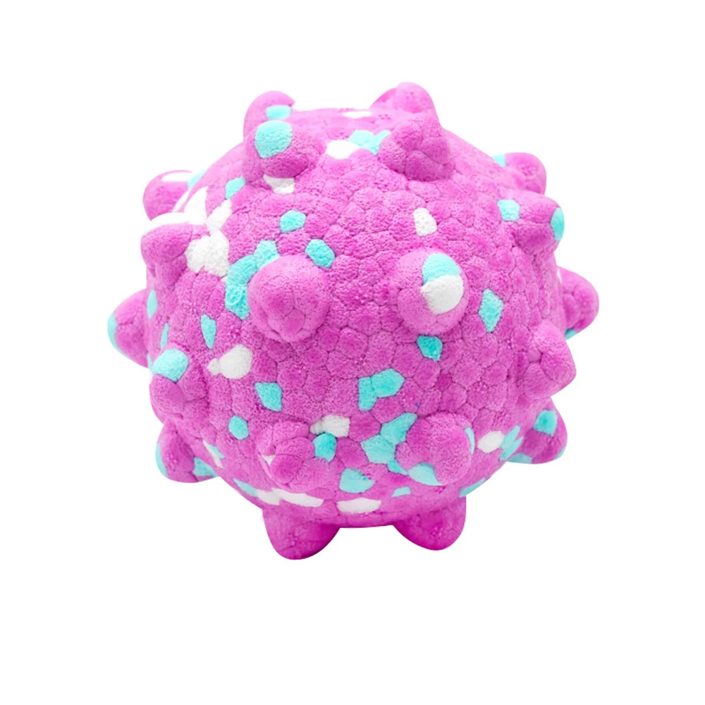Pink spiky plush ball with white and light blue spots on a white background