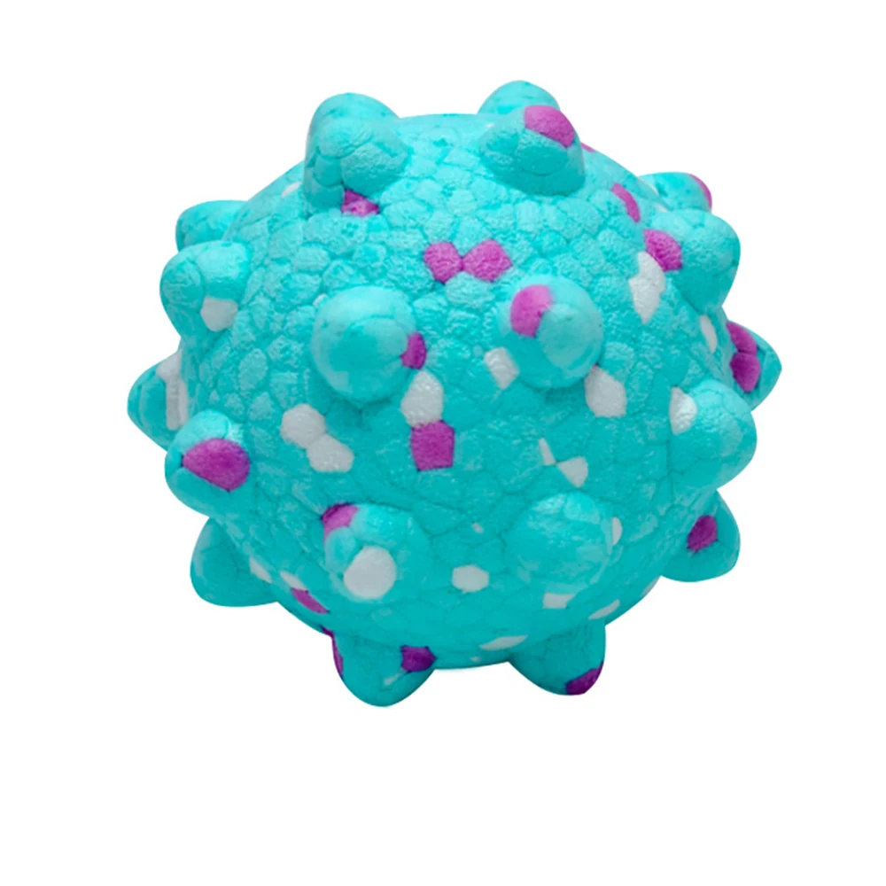 A teal spiky massage ball with white and purple dots.