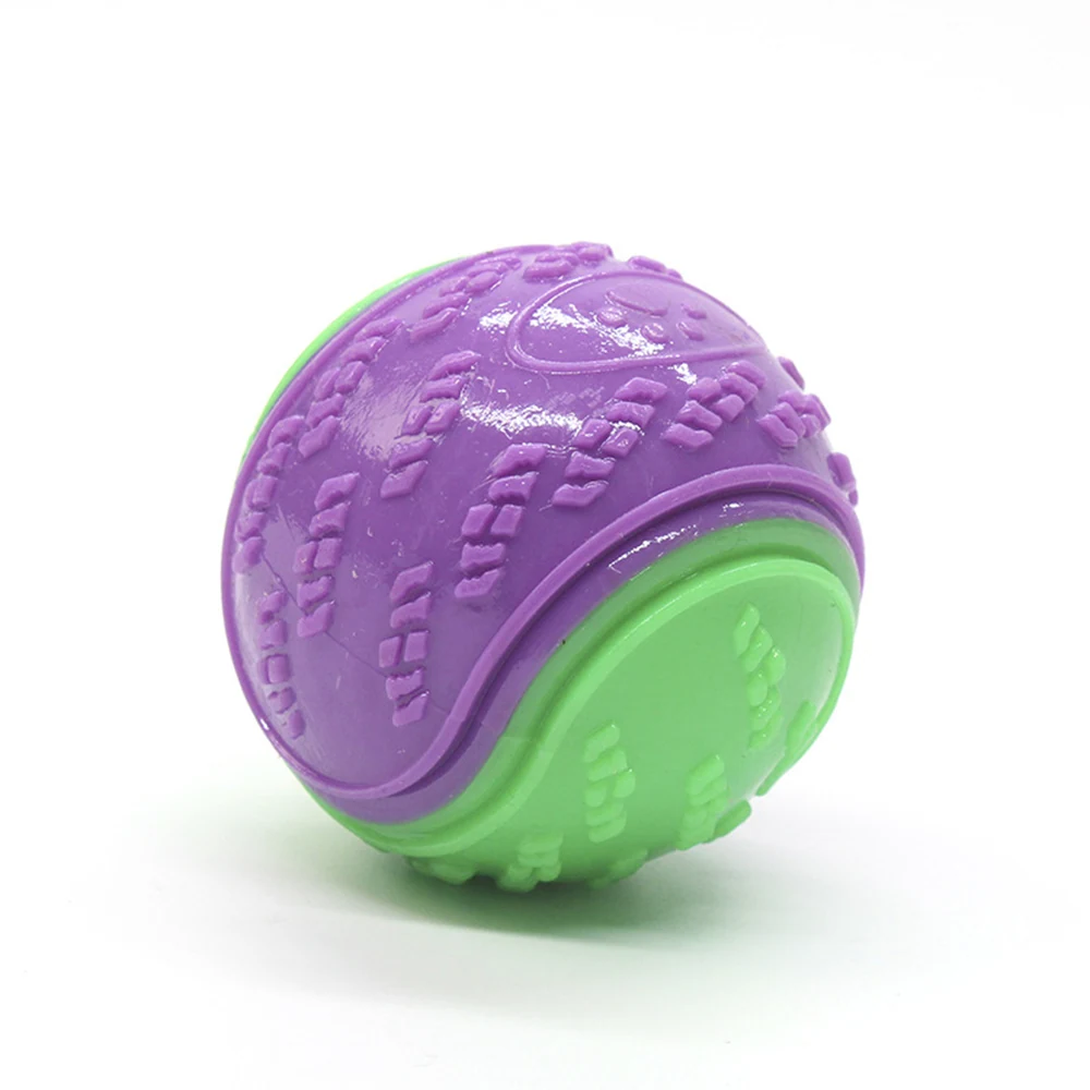 A purple and green textured spherical pet toy on a white background