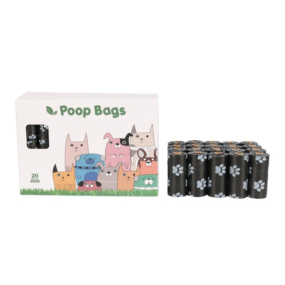 Box of poop bags with cartoon dogs next to a roll of black bags printed with paw prints