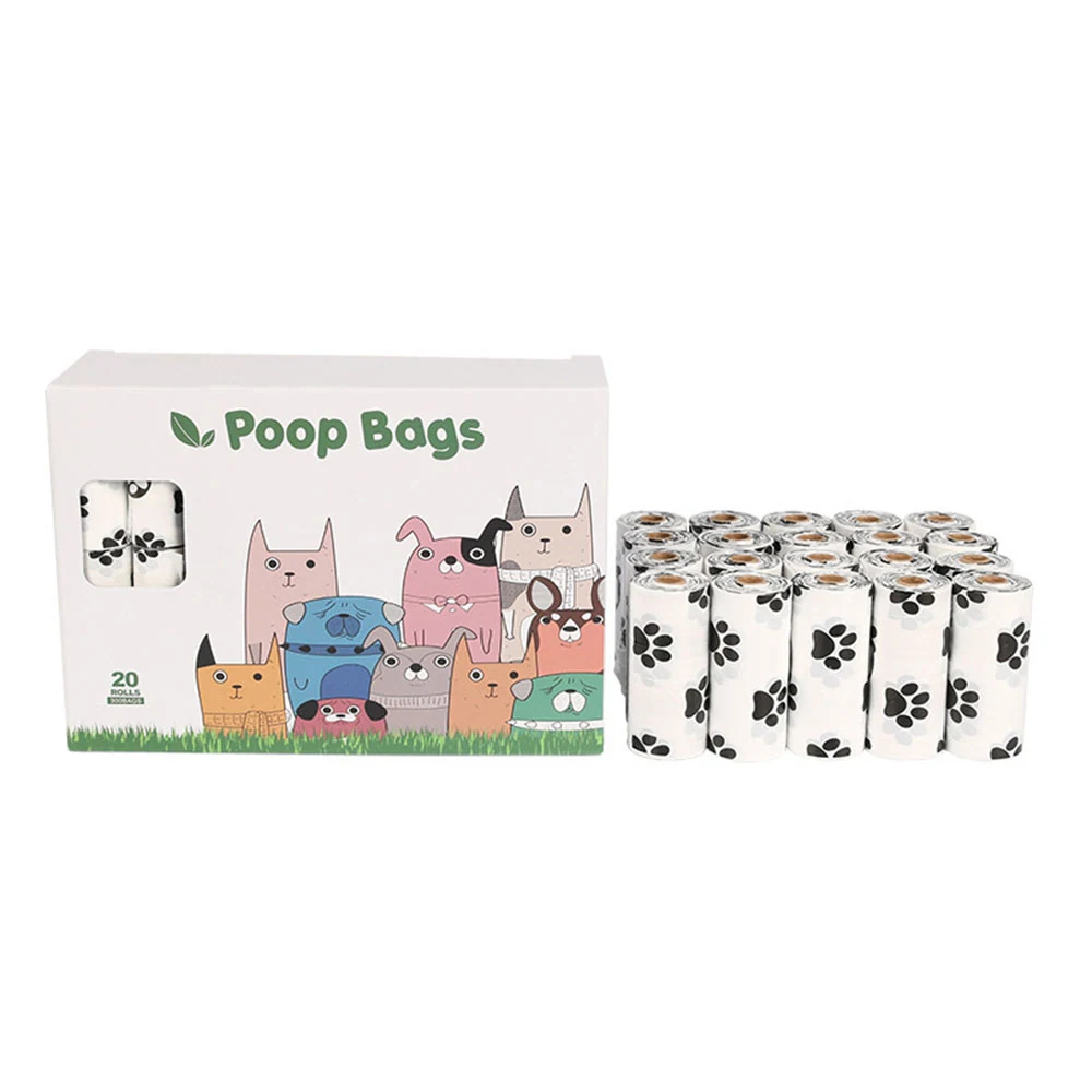Box of 20 poop bags with cartoon dog design and stack of rolls featuring paw prints on white background.