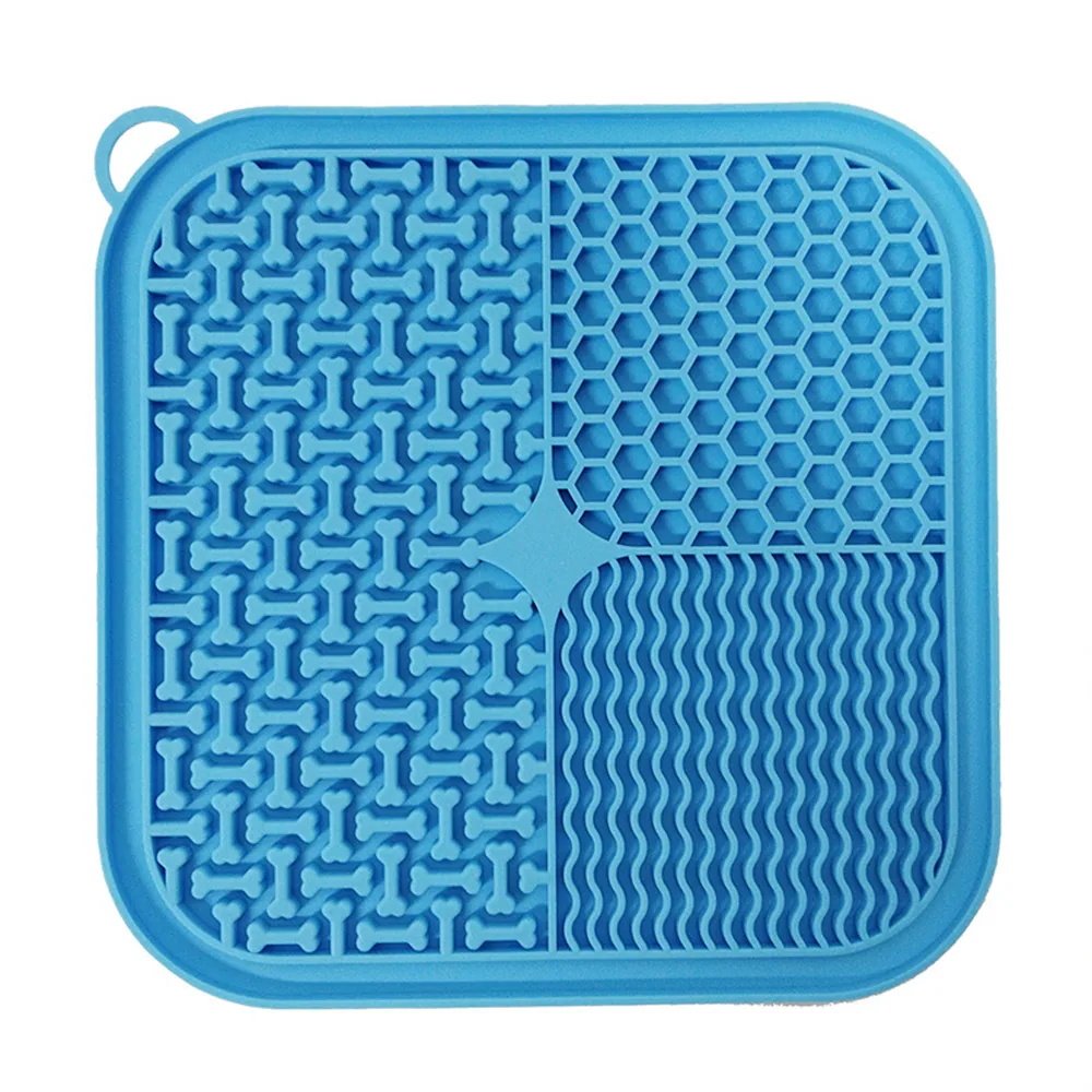 Blue silicone square mat with textured patterns including bones, hexagons, and waves, with a corner loop.