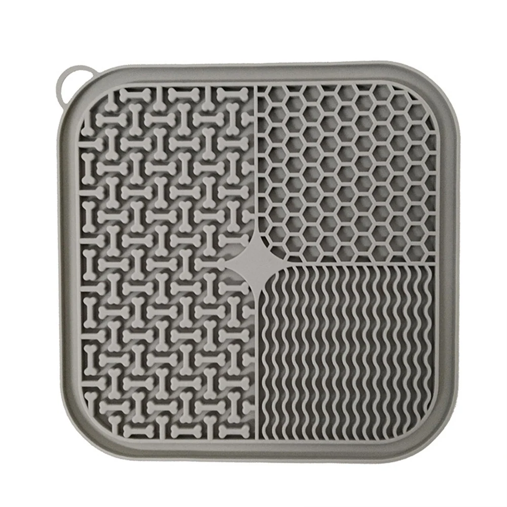 Grey silicone pet lick mat featuring four textured sections with bone, honeycomb, and wavy patterns.
