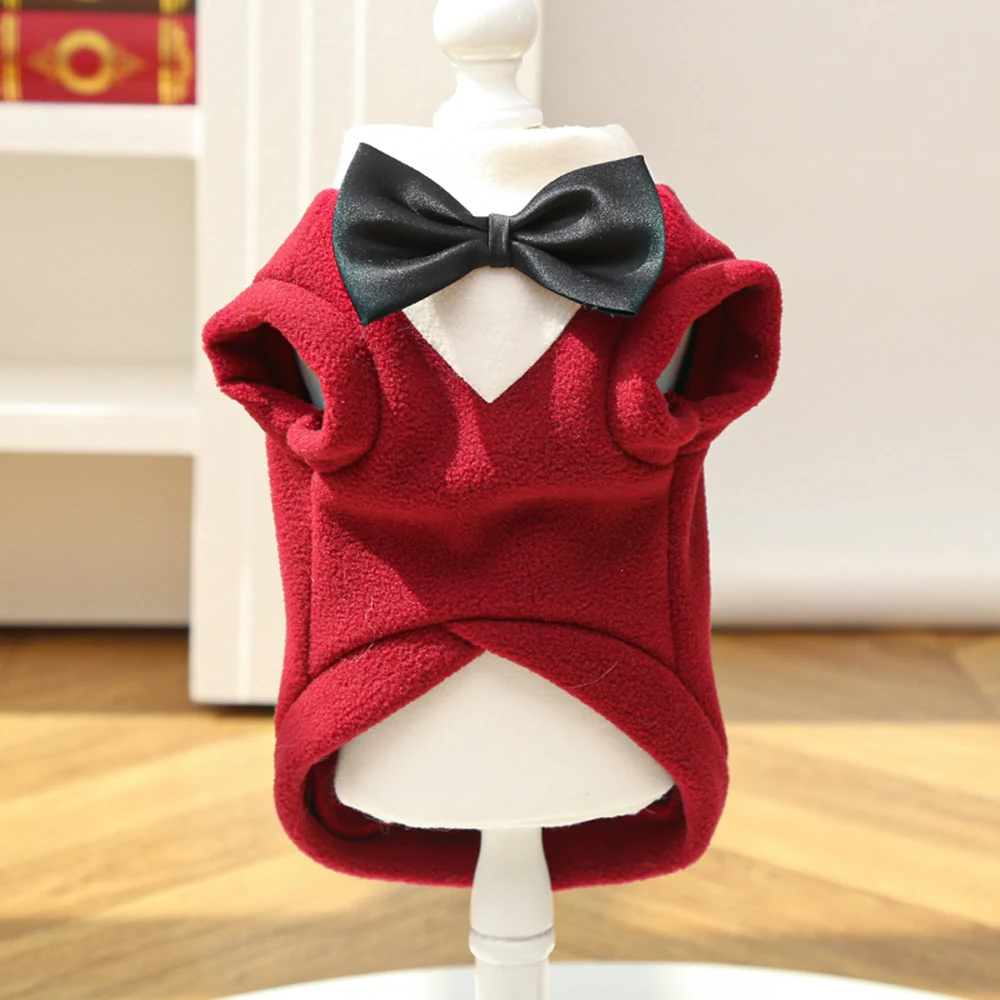 Red fleece pet vest with a black bow tie displayed on a white mannequin