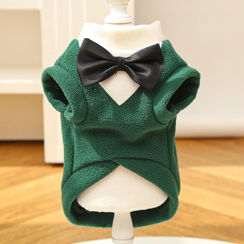 Green fleece pet vest with a black bow tie displayed on a white mannequin.