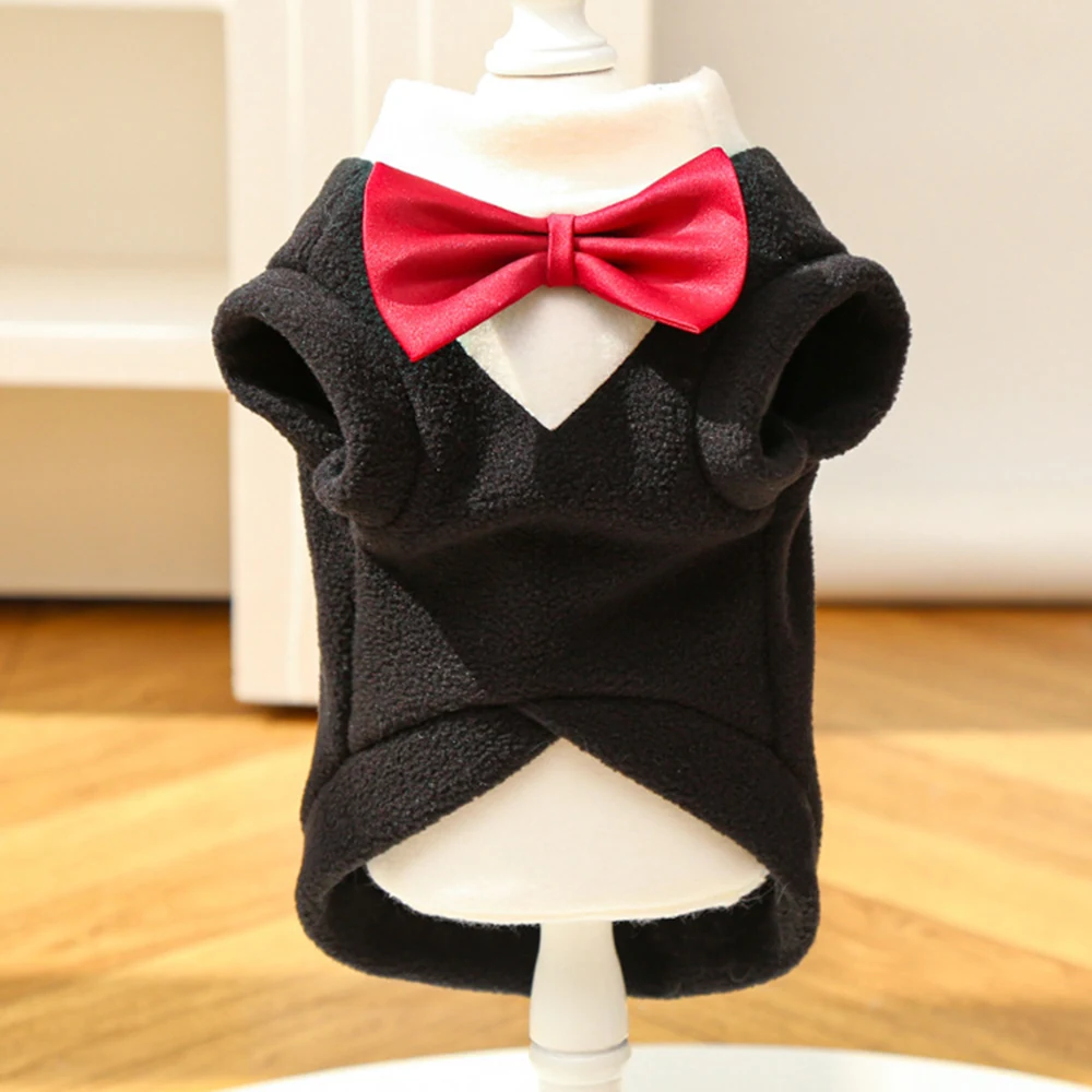 Black fleece pet tuxedo costume with red bow tie on a white mannequin stand
