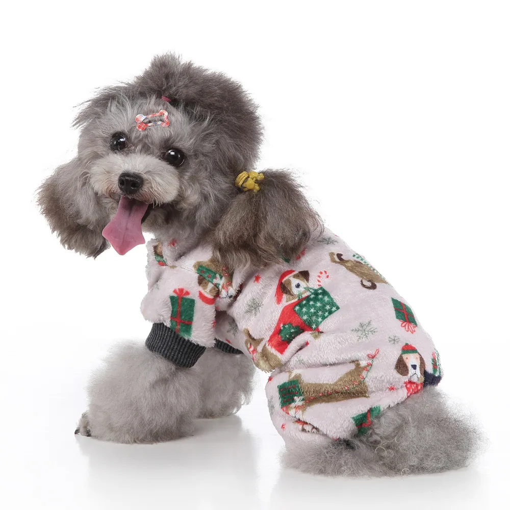 A grey poodle wearing a white fluffy Christmas pajama suit with a dog and gift box print.