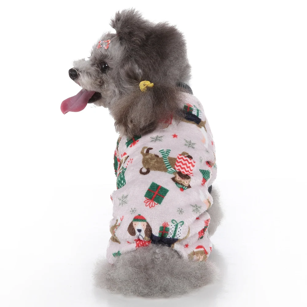 Grey poodle sitting in profile wearing a white fleece dog outfit with a holiday print