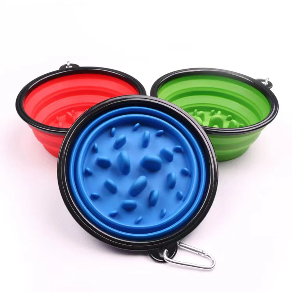 Three collapsible silicone dog bowls in red, green, and blue with slow feeder bumps and carabiners