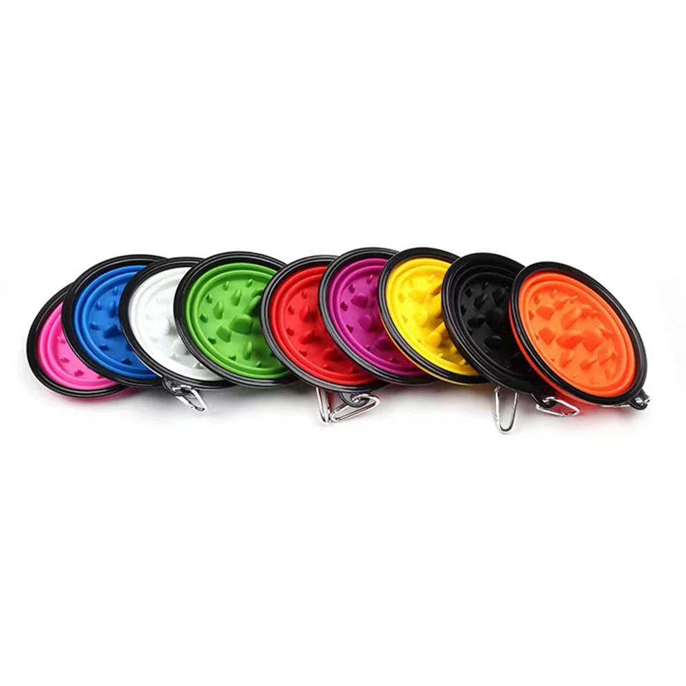 A row of colorful collapsible silicone pet bowls with carabiner clips.