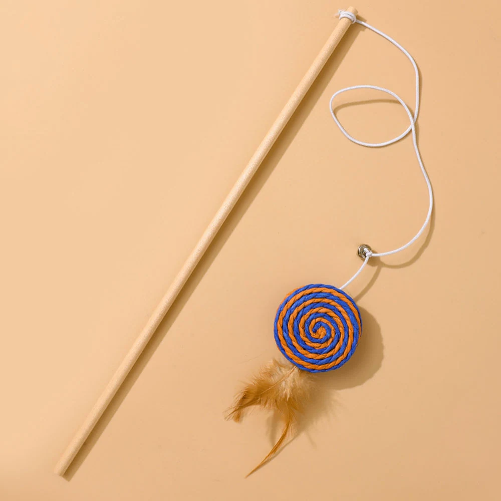 Wooden cat wand toy with white string, blue and orange spiral disc, and feathers on beige background