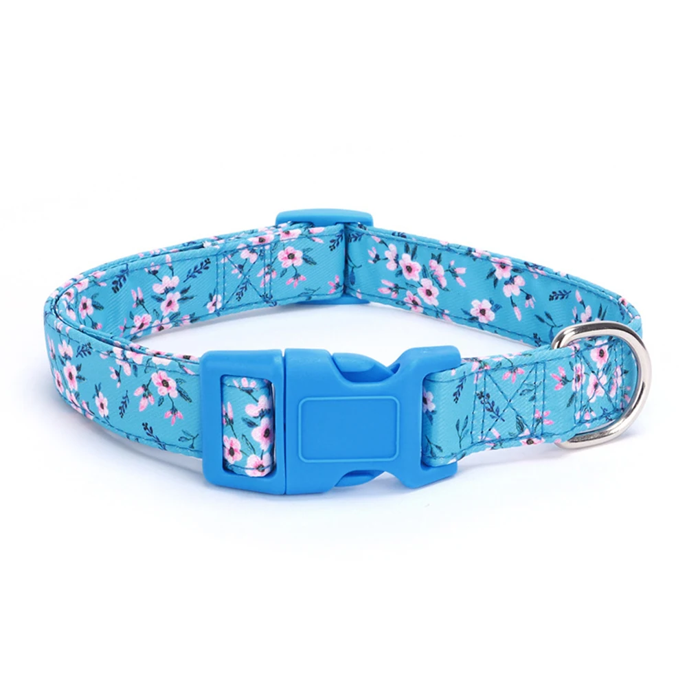 Blue dog collar with pink floral pattern and blue plastic buckle