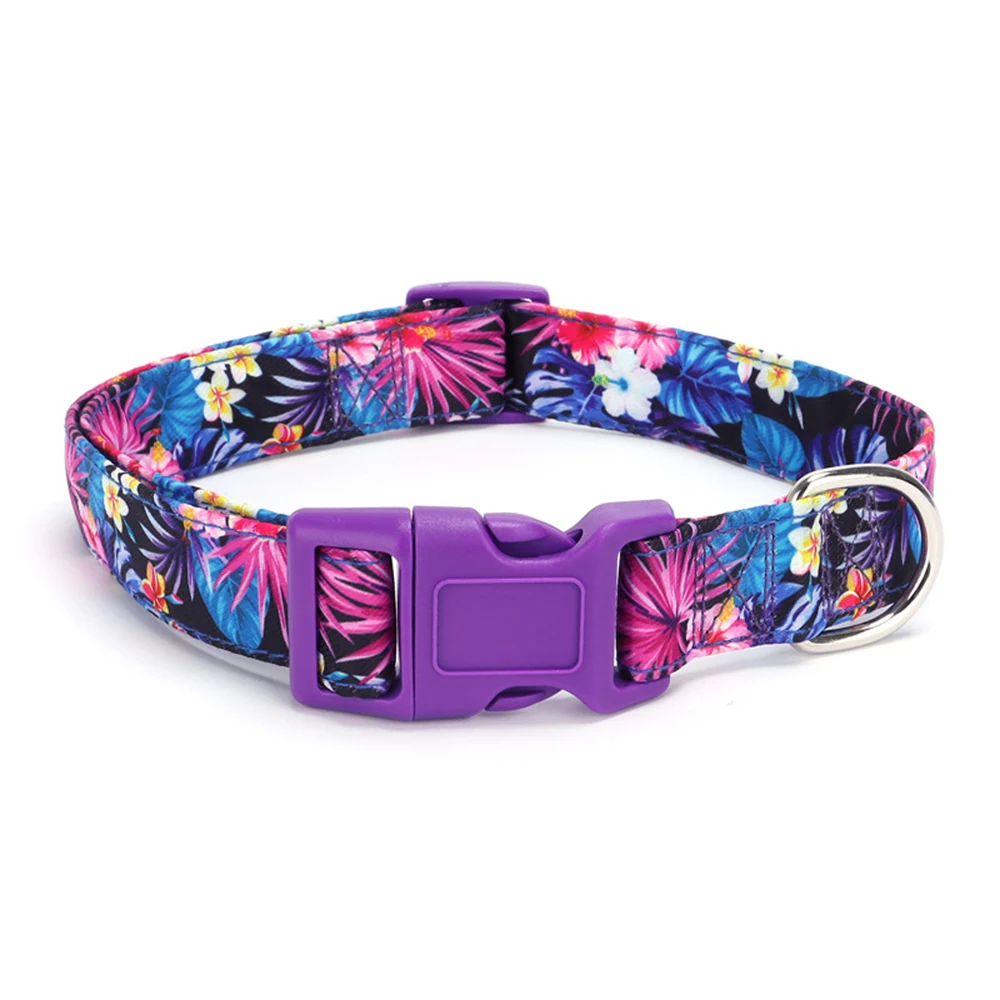 A pet collar with a tropical floral pattern featuring purple plastic buckles and a metal D-ring