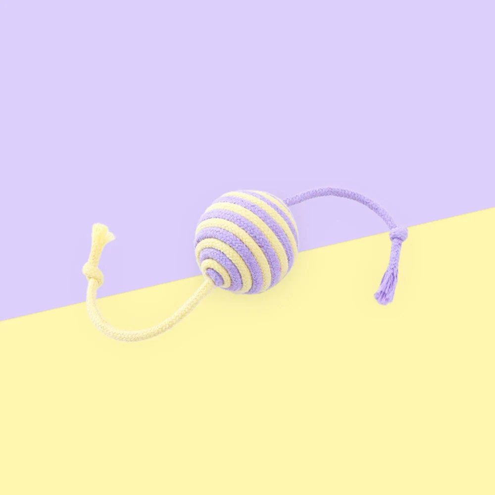 Purple and yellow striped rope ball toy with two cords on a pastel background.